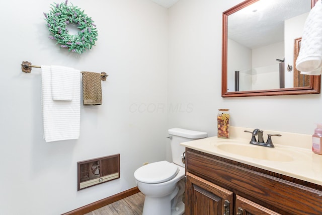333 Salem Rd, Caledonia, OH 43314 - full bath with vanity, toilet, wood finished floors, heating unit, and baseboards