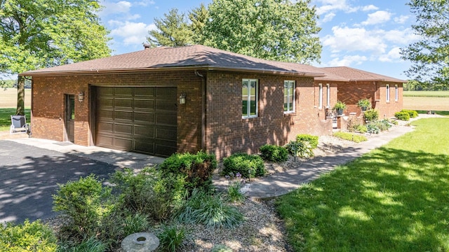 333 Salem Rd, Caledonia, OH 43314 - view of side of property with brick siding, driveway, an attached garage, and a lawn