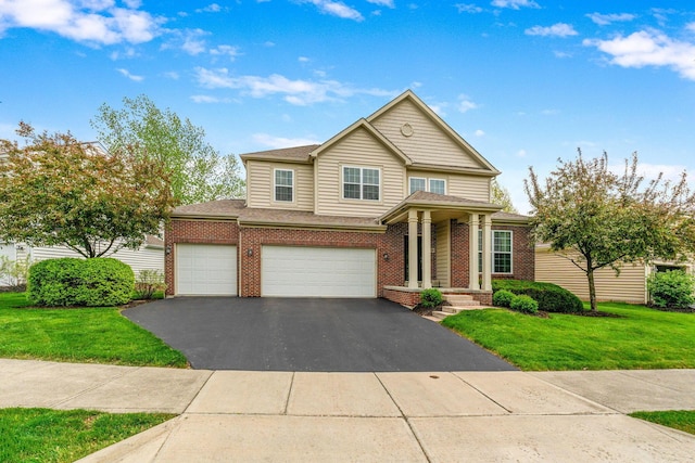 traditional home with an attached garage, a front yard, driveway, and brick siding
