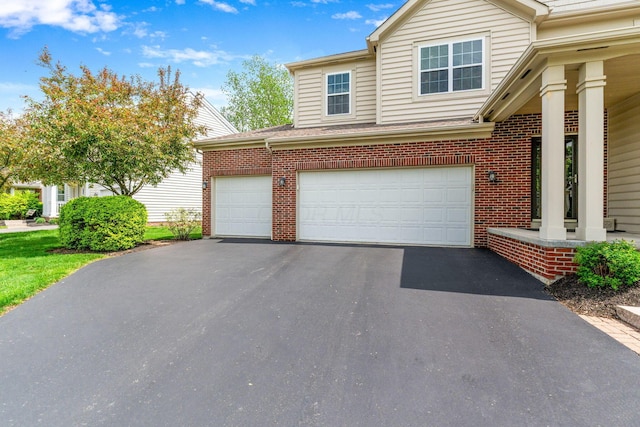 view of property exterior featuring a garage, aphalt driveway, and brick siding