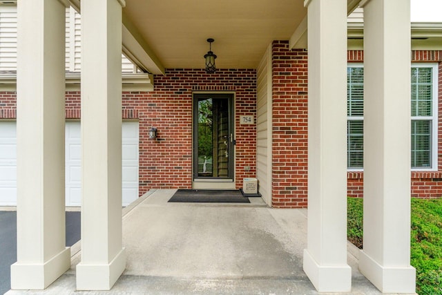 view of exterior entry featuring brick siding