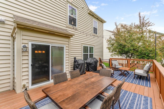 deck with grilling area and outdoor dining space