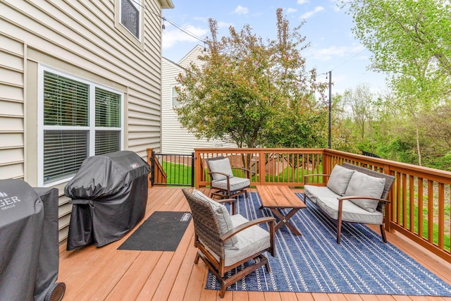 wooden terrace with grilling area and an outdoor hangout area