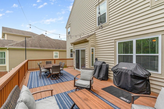 deck featuring grilling area and outdoor dining space