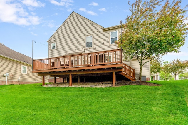 rear view of property with a lawn and a deck