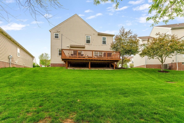 back of house featuring a lawn, a wooden deck, and central air condition unit