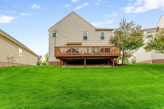 back of property featuring a wooden deck and a yard