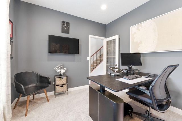 carpeted home office featuring baseboards