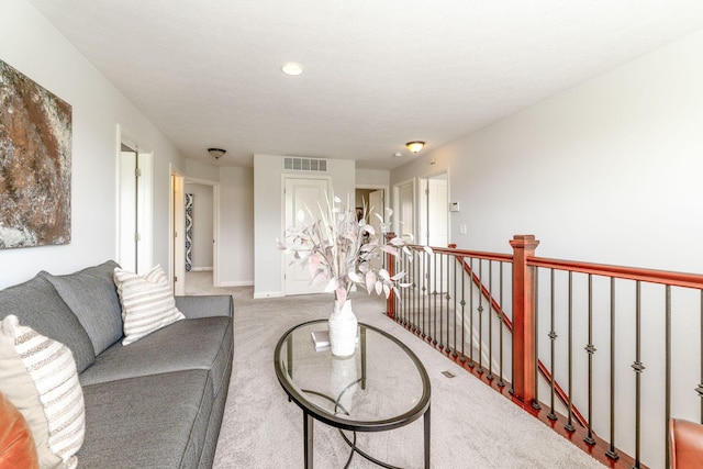 living room with visible vents, carpet flooring, and baseboards