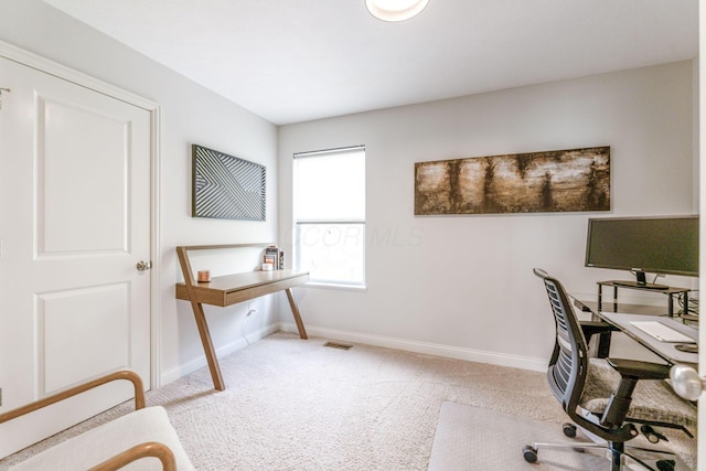 office space featuring carpet floors, baseboards, and visible vents