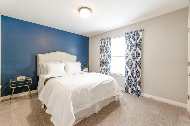 carpeted bedroom featuring baseboards