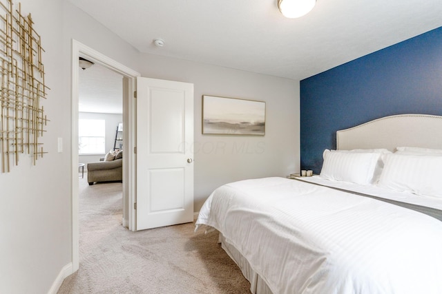 bedroom featuring baseboards and carpet flooring