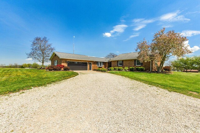 1012 Lake Fork Rd, Utica, OH 43080 - single story home featuring an attached garage, a front lawn, driveway, and brick siding