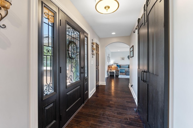 1012 Lake Fork Rd, Utica, OH 43080 - foyer with baseboards, dark wood-type flooring, a barn door, recessed lighting, and arched walkways