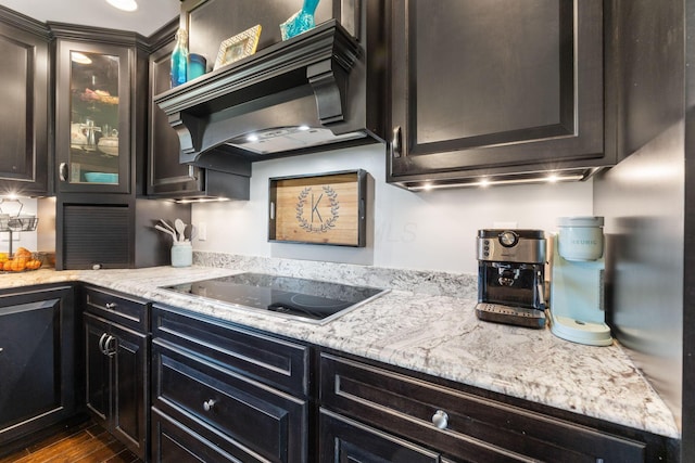 1012 Lake Fork Rd, Utica, OH 43080 - kitchen featuring dark wood-style flooring, black electric cooktop, wall chimney exhaust hood, and glass insert cabinets