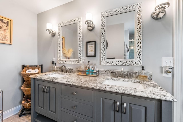 1012 Lake Fork Rd, Utica, OH 43080 - full bathroom featuring double vanity, baseboards, a sink, and wood finished floors