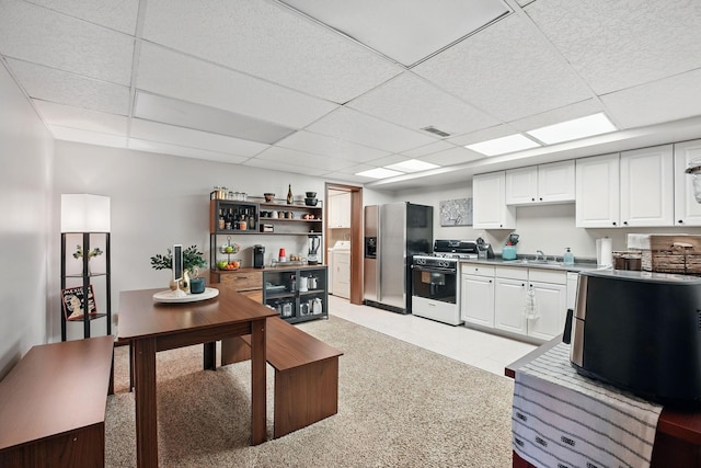 1012 Lake Fork Rd, Utica, OH 43080 - kitchen with stainless steel refrigerator with ice dispenser, washer / clothes dryer, visible vents, a paneled ceiling, and gas stove