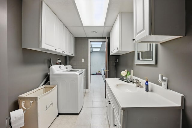 1012 Lake Fork Rd, Utica, OH 43080 - washroom with a sink, cabinet space, light tile patterned floors, and washing machine and dryer