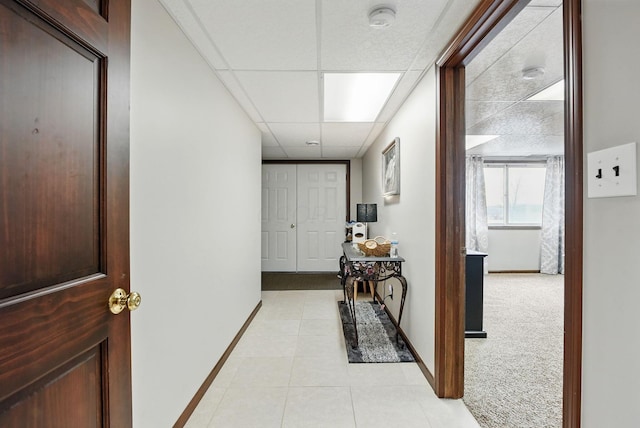 1012 Lake Fork Rd, Utica, OH 43080 - hallway featuring baseboards, light tile patterned floors, a drop ceiling, and light carpet