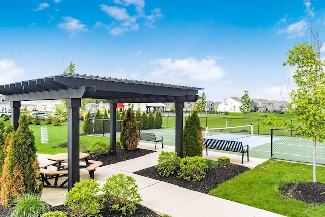 view of home's community featuring fence, a pergola, a tennis court, and a lawn