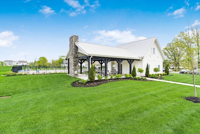 view of property exterior featuring a yard, a gazebo, a chimney, and board and batten siding