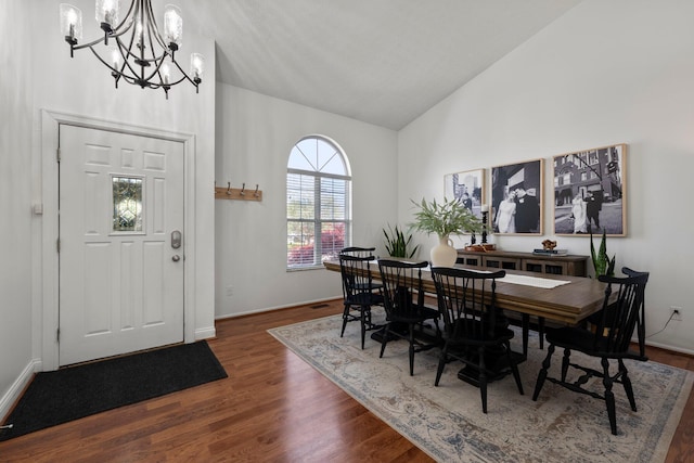 1479 Brookforest Dr, Columbus, OH 43204 - dining area with high vaulted ceiling, baseboards, wood finished floors, and a chandelier