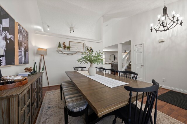 1479 Brookforest Dr, Columbus, OH 43204 - dining space featuring an inviting chandelier, dark wood-style flooring, and stairs