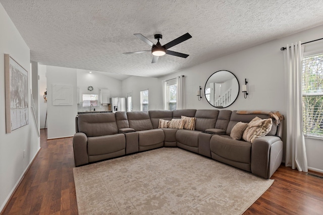 1479 Brookforest Dr, Columbus, OH 43204 - living area with dark wood-style flooring, a textured ceiling, ceiling fan, and baseboards