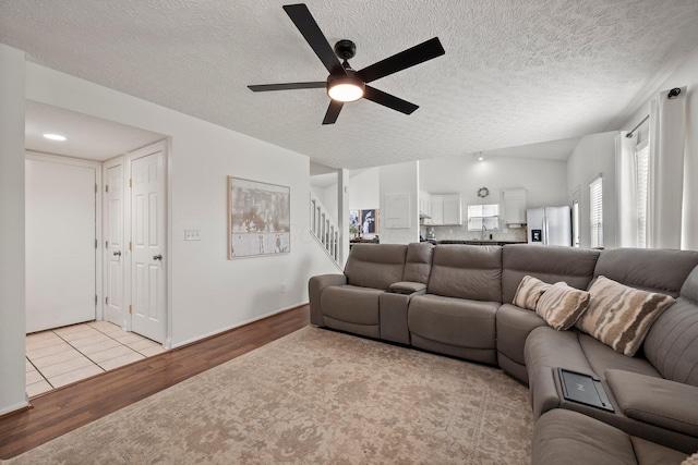 1479 Brookforest Dr, Columbus, OH 43204 - living room featuring light wood-type flooring, a ceiling fan, stairs, and a textured ceiling