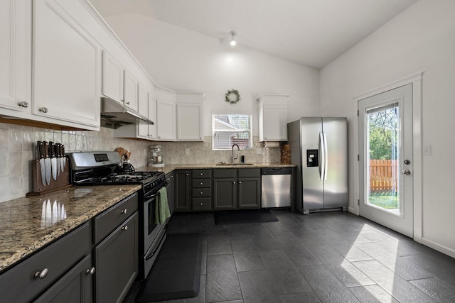 1479 Brookforest Dr, Columbus, OH 43204 - kitchen featuring under cabinet range hood, white cabinets, a sink, appliances with stainless steel finishes, and vaulted ceiling
