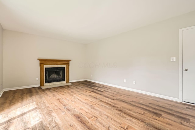 3861 Trestle Ct, Columbus, OH 43204 - unfurnished living room with wood finished floors, baseboards, and a fireplace