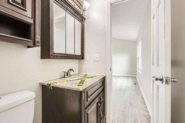 3861 Trestle Ct, Columbus, OH 43204 - half bath with toilet, vanity, wood finished floors, and baseboards