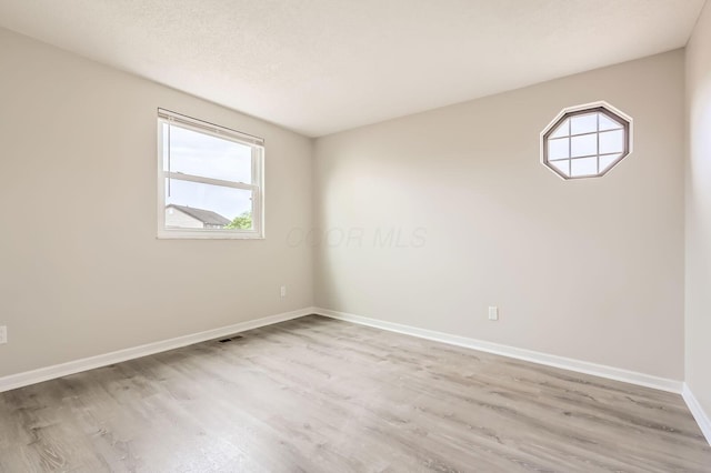 3861 Trestle Ct, Columbus, OH 43204 - unfurnished room with wood finished floors, plenty of natural light, and baseboards