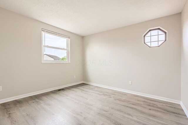 3861 Trestle Ct, Columbus, OH 43204 - unfurnished room with wood finished floors, plenty of natural light, and baseboards