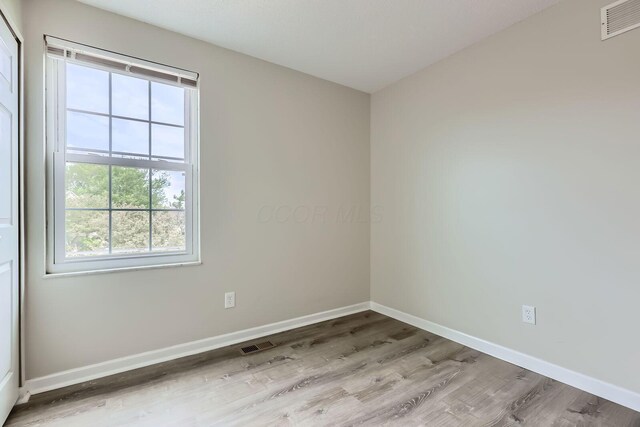 3861 Trestle Ct, Columbus, OH 43204 - spare room featuring plenty of natural light, light wood-type flooring, and baseboards