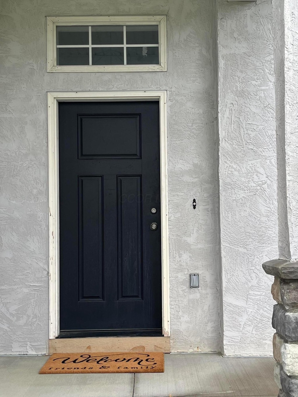 entrance to property featuring stucco siding