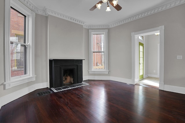 unfurnished living room featuring ceiling fan, a fireplace with flush hearth, plenty of natural light, and wood finished floors
