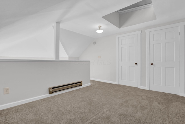 additional living space featuring baseboards, a baseboard radiator, carpet, and lofted ceiling