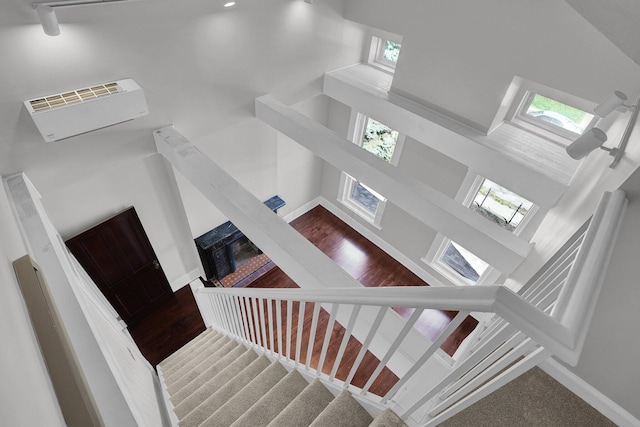 stairs featuring baseboards and a towering ceiling