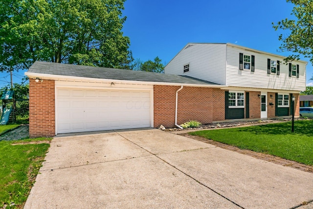 3950 Monterey Dr, Grove City, OH 43123 - view of front of property featuring brick siding, driveway, a front yard, and a garage