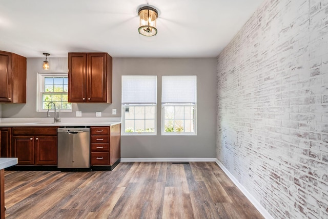 3950 Monterey Dr, Grove City, OH 43123 - kitchen featuring stainless steel dishwasher, a sink, light countertops, dark wood-type flooring, and baseboards