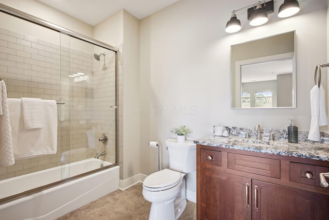 full bathroom with toilet, baseboards, bath / shower combo with glass door, vanity, and tile patterned floors