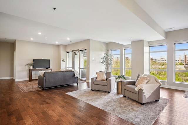living room featuring plenty of natural light, dark wood-style flooring, baseboards, and recessed lighting