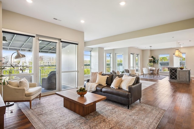 living room with dark wood-style flooring and recessed lighting