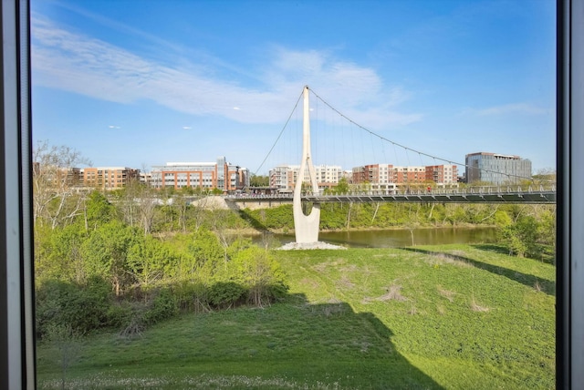 view of yard with a water view and a view of city