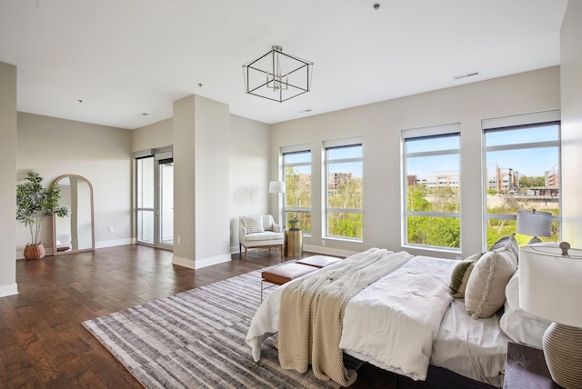 bedroom with dark wood-style floors and baseboards