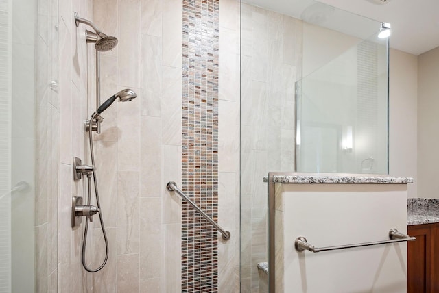 bathroom with a stall shower and vanity