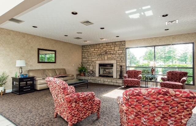 4670 Shalers Dr Unit 49A, Columbus, OH 43228 - living area with carpet, a fireplace, and recessed lighting