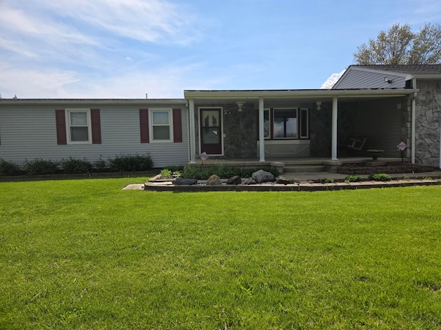 view of front of property featuring stone siding and a front yard