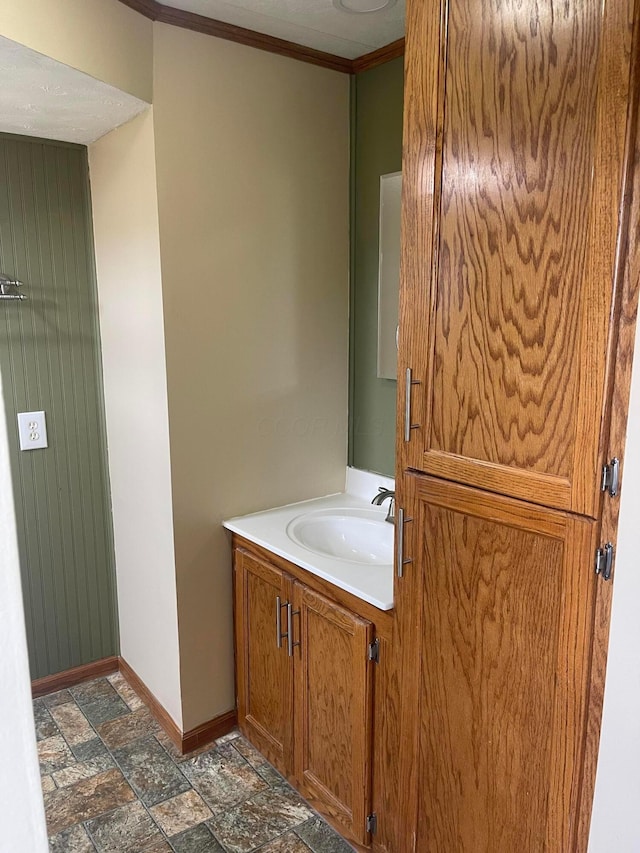 10519 Darby Creek Rd, Orient, OH 43146 - bathroom featuring stone finish floors, baseboards, crown molding, and vanity